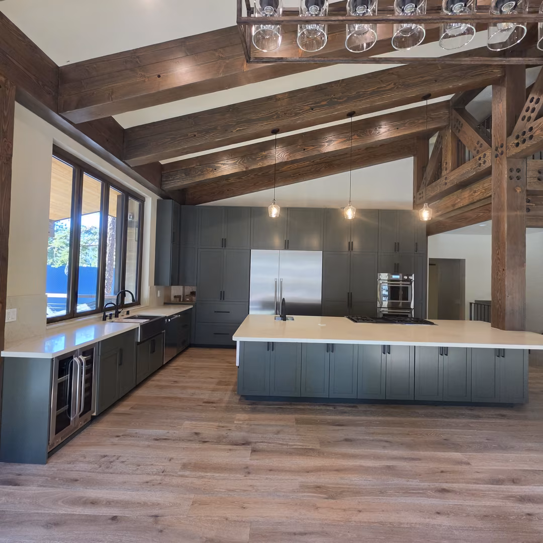 Kitchen with green Shaker cabinets, a large island and timber beams, built by 3R WoodworX